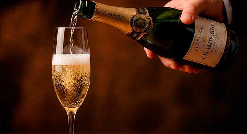 Champagne y espumosos. Sirviendo una copa de champagne.
